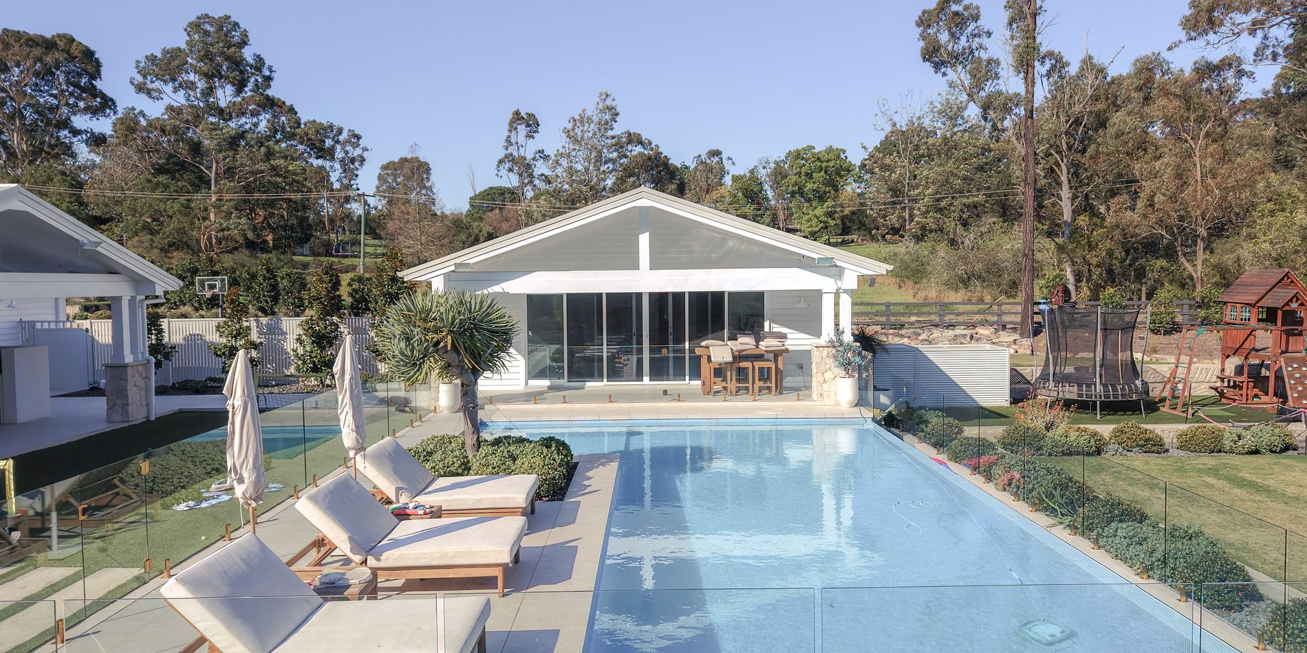 Pool, loungers and the glazed cabana