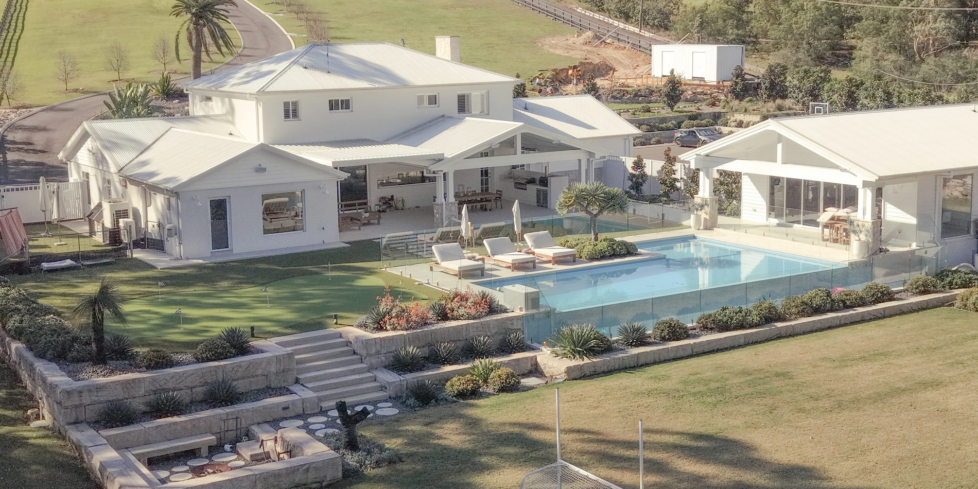 The whole property from the air — pool, putting green and lawn