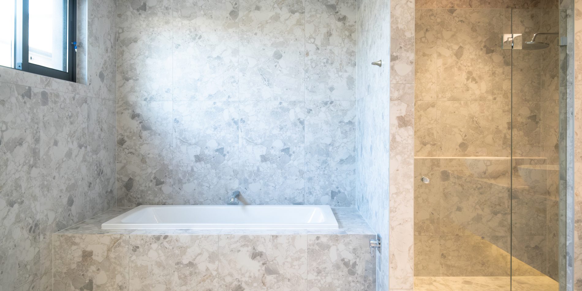 The main bathroom, bath and shower in marble