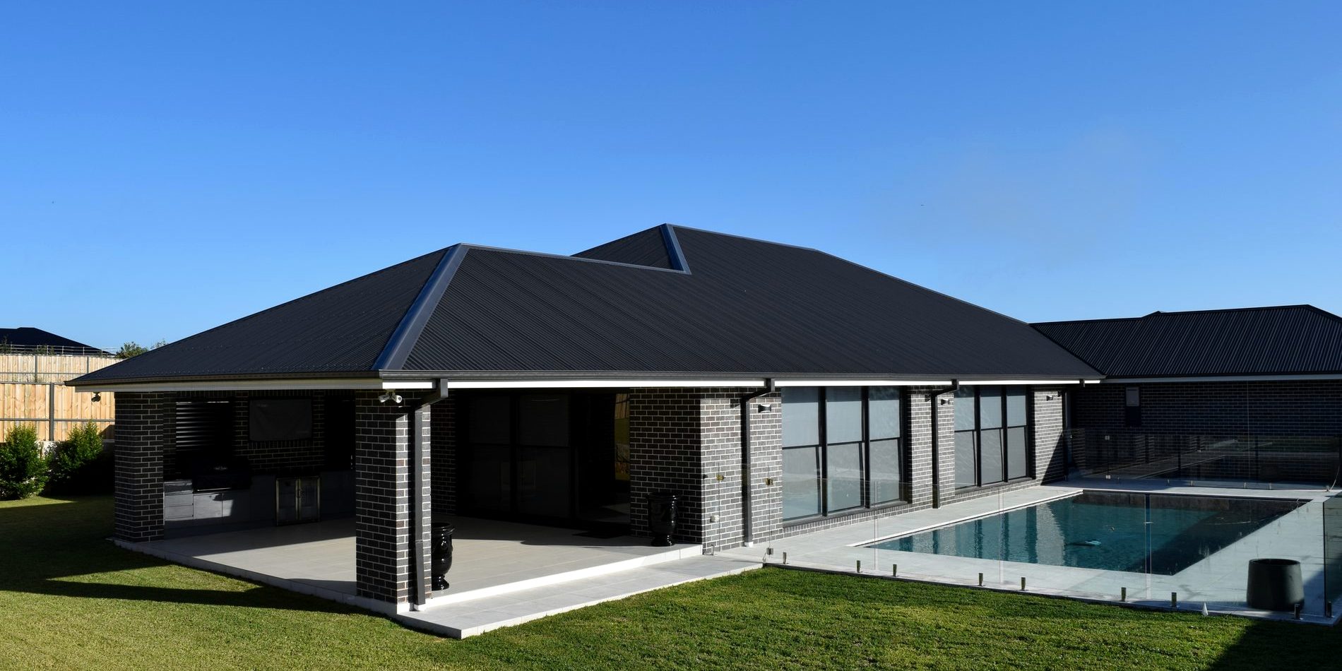 The rear elevation, terrace and pool