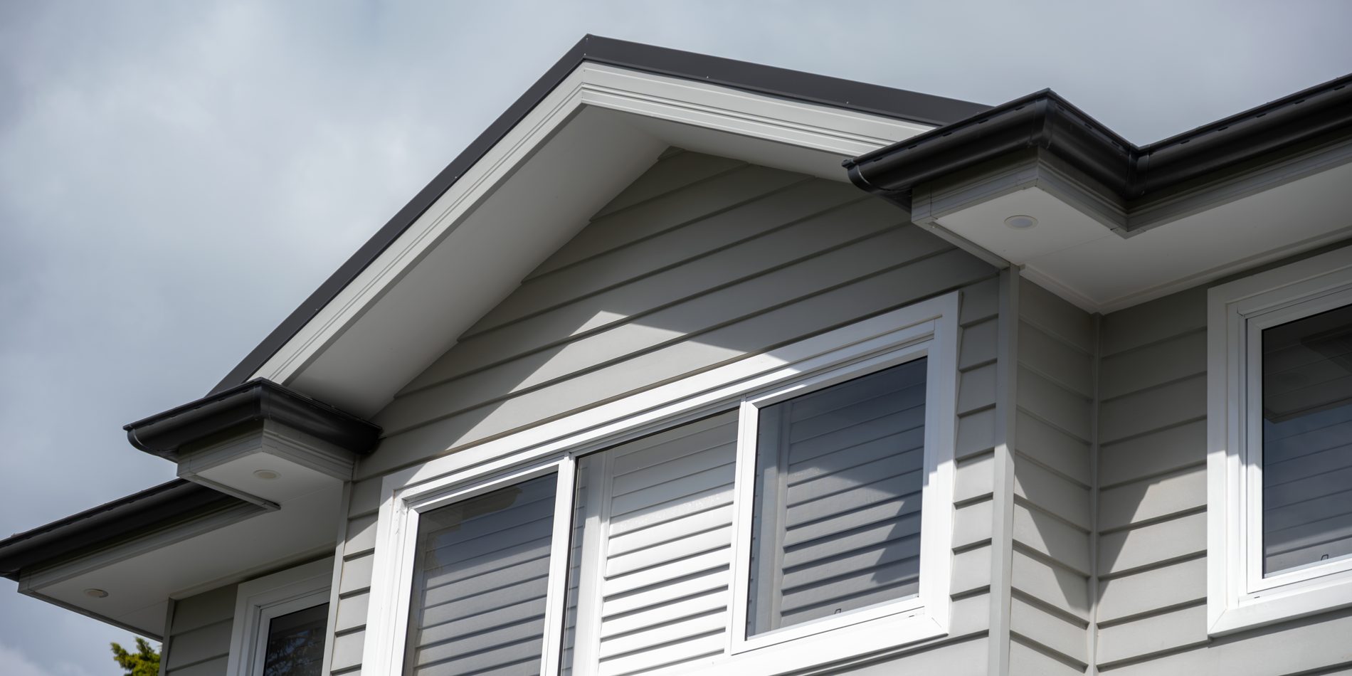 Weatherboard and shutters at the upper storey