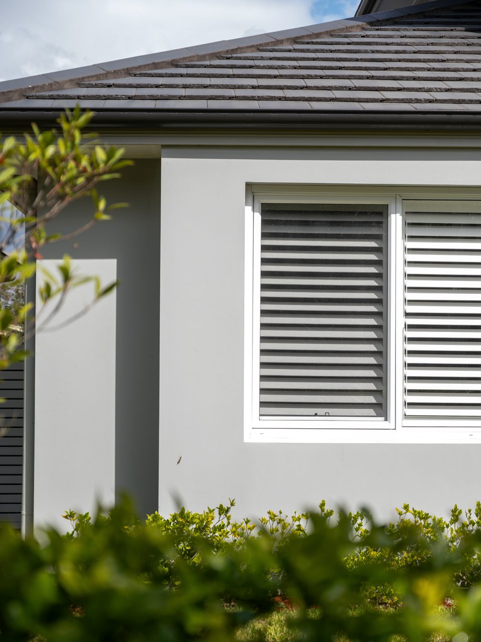 A shuttered window under the gable