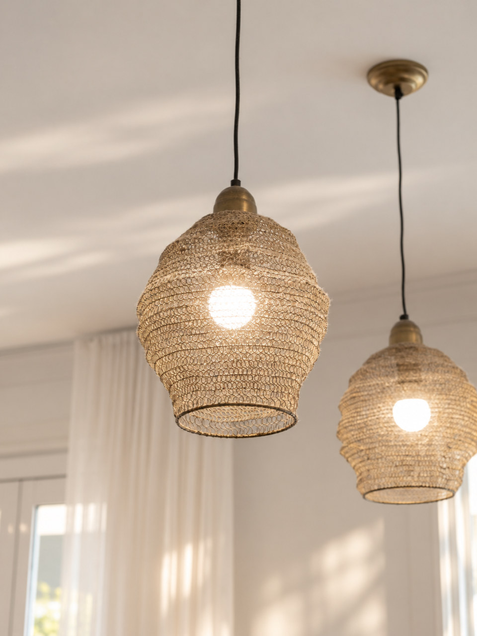 Woven brass pendants over the island