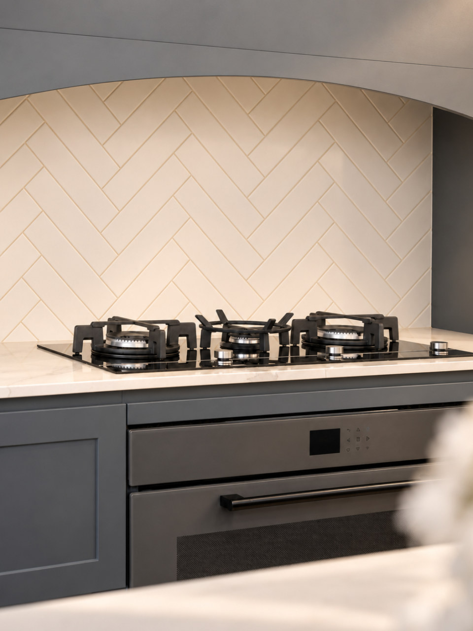 Herringbone tiles under the arched rangehood